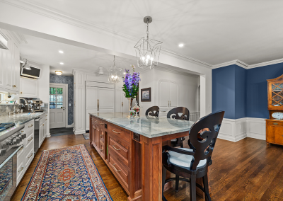 Traditional kitchen island with view to back entry mudroom